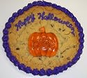 Scott's Cakes 1 lb. Chocolate Chip Cookie Cake with Gummie Pumpkin Purple Trim