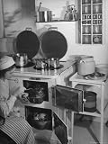 Swedish Woman in Native Costume Demonstrates Using the Double Oven Feature For Cooking Photographic Poster Print by Margaret Bourke-White, 24x32