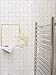 Cool white tiled urban modern bathroom towel rail and display from Arcaid