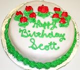 Chocolate-Strawberry-Chocolate Chip Lovers Cake Topped with White Chocolate Green Trim and Red Flowers