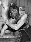 Coal Miner Mabrey Evans Scrubbing His Arm in Tub of Hot Water Photographic Poster Print by Alfred Eisenstaedt, 12x16