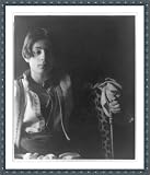 Historic Print (S): [Kahlil Gibran in Middle Eastern(?) costume with leopard skin and staff, seated]