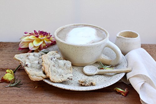 Handmade white glazed stoneware tea or latte cups with saucers.