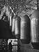 Line of 500 lbs Bombs Jiggling Along on Overhead Conveyor Hooks Abover Worker Photogr...