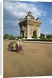 Canvas Prints of Woman on a bicycle with a trailer rides past the Anousavari from Robert Harding