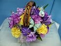 Floral Centerpiece with Silk Purple Iris, Yellow Carnations Bird and Butterflies in a Basquet