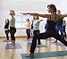 Teacher Guides Student in Yoga Class - 36