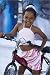 Girls Bikes 20 photo poster Young Cuban girl on bike, Callejon de Hamel. in size: 20 x 30 cm by G. Doyle
