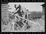 Photo Sharpening knife of old mowing machine on farm near Hyde Park, Vermont 1936