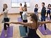 Teacher Guides Student in Yoga Class - 60