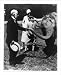 Historic Print (M): [William T. Hornaday holding trunk of elephant, which woman and boy are petting]