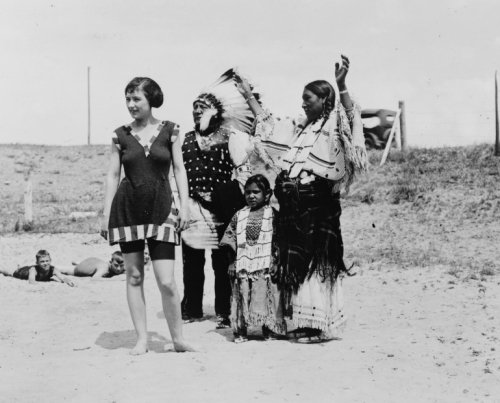 1923 photo Native American family standing on beach with Euro-American woman in bathing suit. White