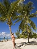 Woman Leaning Against Palm Tree, Princess Cays, Eleuthera Island, West Indies, Caribbean Photographic Poster Print by Richard Cummins, 9x12