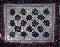 Mardi Gras Stack + Whack bed quilt