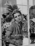 Wistful Russian Girl Eyeing a Rhinestone Bracelet at a Display of British Fashions Photographic Poster Print by Lisa Larsen, 18x24