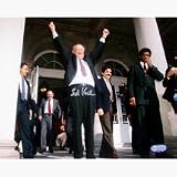 Ed Koch Autographed At City Hall with Arms Raised 8 x 10 Photograph (Unframed)