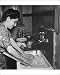 Photographic Prints of Young woman washing clothes at a sink from Mary Evans