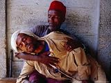 Man Holding Other Man Sick with Malaria, Ethiopia Art Photographic Poster Print by Michael Coyne, 16x12