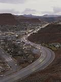 Traffic Flows Through a Desert Town Complete with Rock Formations Photographic Poster Print, 18x24