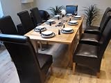 Solid Oak Extending Dining Table and Eight Brown Leather Chairs
