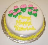 Chocolate-Apricot Lovers Cake Topped with White Chocolate Yellow Trim and Pink Flowers