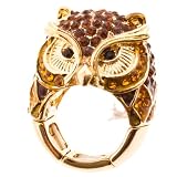 Gold tone stretch band ring with owl design and amber rhinestones.