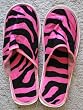 a pair of zebra pink / black slippers