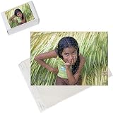 Photo Jigsaw Puzzle of Young village girl sits on bed of newly cut crops in from AWL Discover Images
