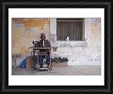Framed Print of A man works his sewing machine on Ibo Island from AWL Discover Images.com