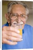 Box Canvas Print of Elderly man holding a glass of juice from Science Photo Library