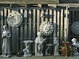 Concrete Statues, Bird Baths and Sculpture against a Wooden Fence Photographic Poster Print, 24x32