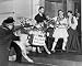 1941 photo Man and woman in traditional Greek costumes pulling a burro with flower packs on its back