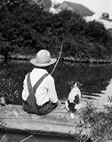 1920s 1930s Farm Boy Wearing Straw Hat and Overalls Sitting on Log with Spotted Dog Fishing in Pond - 24