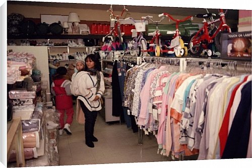 Canvas Print of Inuit mother shopping for clothes at a store in Igloolik from ArcticPhoto