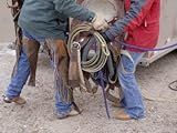 IMAGE OF A Ranch Couple Work Together to Lift a Saddle into a Trailer Stretched Canvas Poster Print, 24x32
