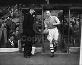 AFC466 - The Captain of Arsenal football team, Joe Mercer (1914 - 1990), leads the team onto the field for their match against Charlton Athletic at Highbury. Original Publication: People Disc - HH0241 (Photo by Topical Press Agency/Getty Images)