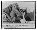 Historic Print (L): [Umberto Nobile, half-length portrait, reclining outdoors and feeding dog Titina]