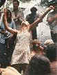 Young Woman with Flute Ecstatically Raising Her Arms, Amid Crowd at Woodstock Music Festival Photographic Poster Print by Bill Eppridge, 18x24