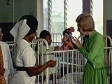 Photography Poster - Mrs. Nixon visits with a child in a hospital in Ghana - 24