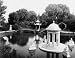ca 1900 photo Pond with garden structures, statuary, and bridge surrounded by trees. Grounds of Vill