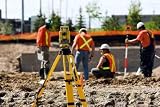 Level on a Tripod with Construction Workers in the Background. - 60W x 40H - Peel and Stick Wall Decal by Wallmonkeys