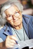 Elderly Woman Solving Crossword Puzzle - 72