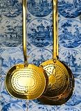 Brass Strainers Hanging on a Tile Wall - 24