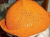 Ht78o , Hand crocheted orange gimp Floppy Hat .