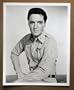 DK01 KISSIN' COUSINS Elvis Presley MINT orig 8x10 still.  Here�s a terrific Original Studio Publicity Still  from the original release of KISSIN COUSINS featuring a great image of ELVIS PRESLEY. There is a stamped on the back of the card.    Studio Still  is in MINT condition. No pinholes, no stains, no tears.       A lobby card is an 11 x 14 inch placard advertising a movie. They were displayed in the theatre lobby to entice moviegoers to go to the box office and buy a ticket.