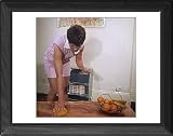Framed Print of DUSTING A COFFEE TABLE from Mary Evans