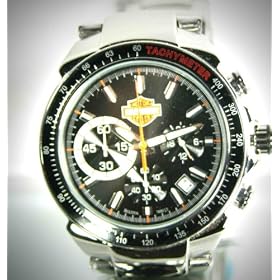 Harley Davidson Men's Chronograph Watch. Black patterned dial. Chronograph. Luminous hands and markers. Stainless steel case and bracelet. Screw back. Fold-over buckle/safety clasp with lock. WR50m/165ft. 78B113
