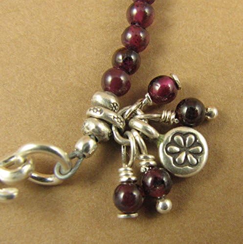 Red garnet bracelet with dangles and charm. Fine and sterling silver.