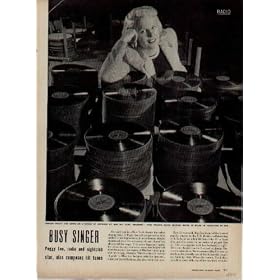 BUSY SINGER - Singer PEGGY LEE leans on a stack of records of her hit tune "Manana." This record alone could bring in $75,000 in royalties in 1948. ..... 1948 LIFE Magazine Article, A4801.