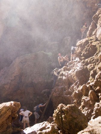 A Crowd Forms at the Base of a Ladder up a Steep Cliff Premium Photographic Poster Print, 24x32